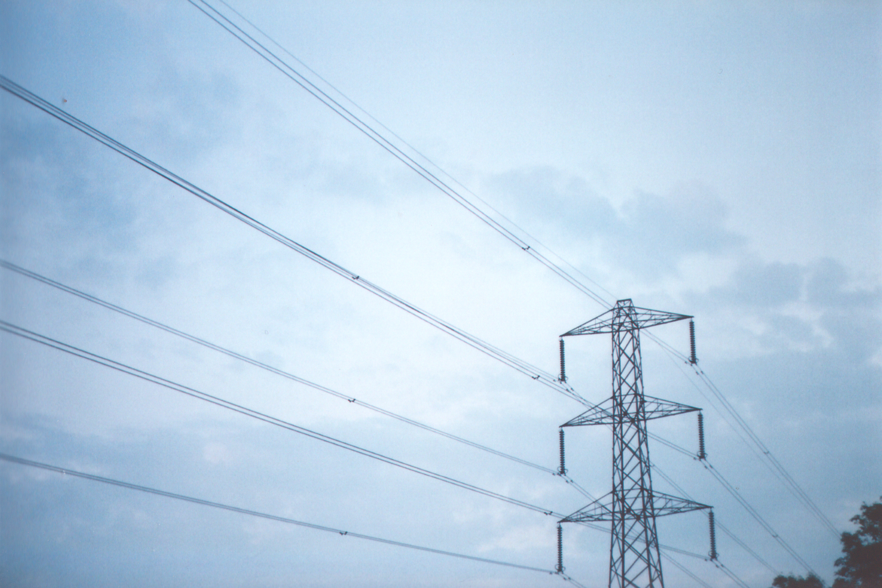 a line of high voltage electrical lines towering above