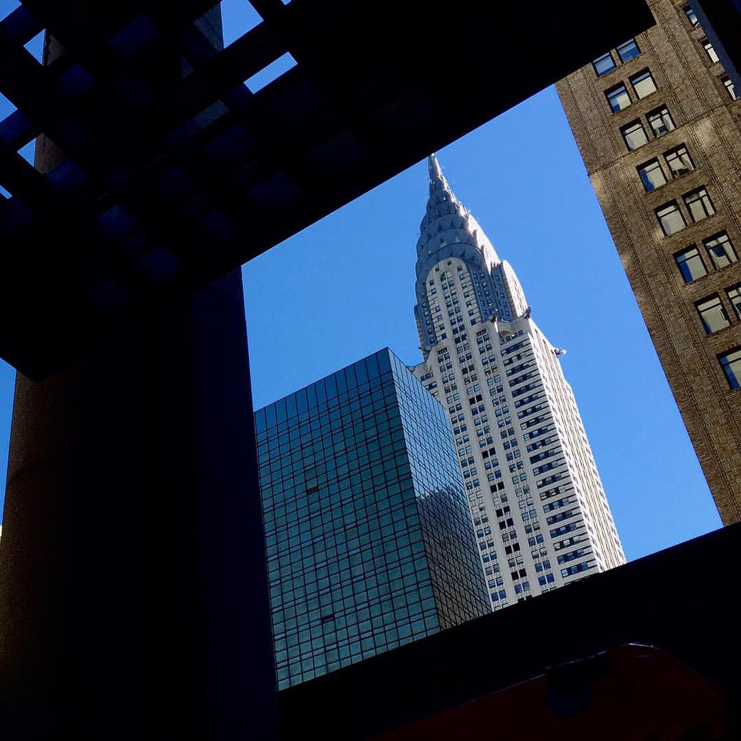 a view from outside of a building that has a spire