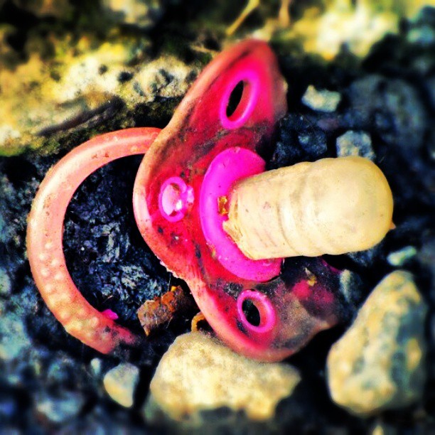 two orange and pink beads on the ground