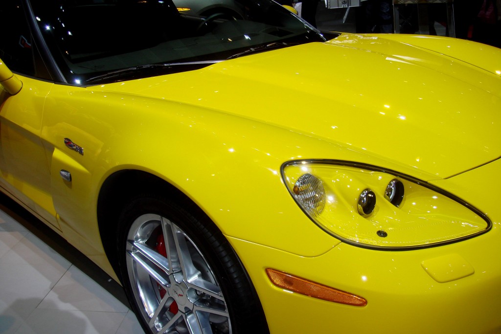 a yellow sports car is on display at an automobile show