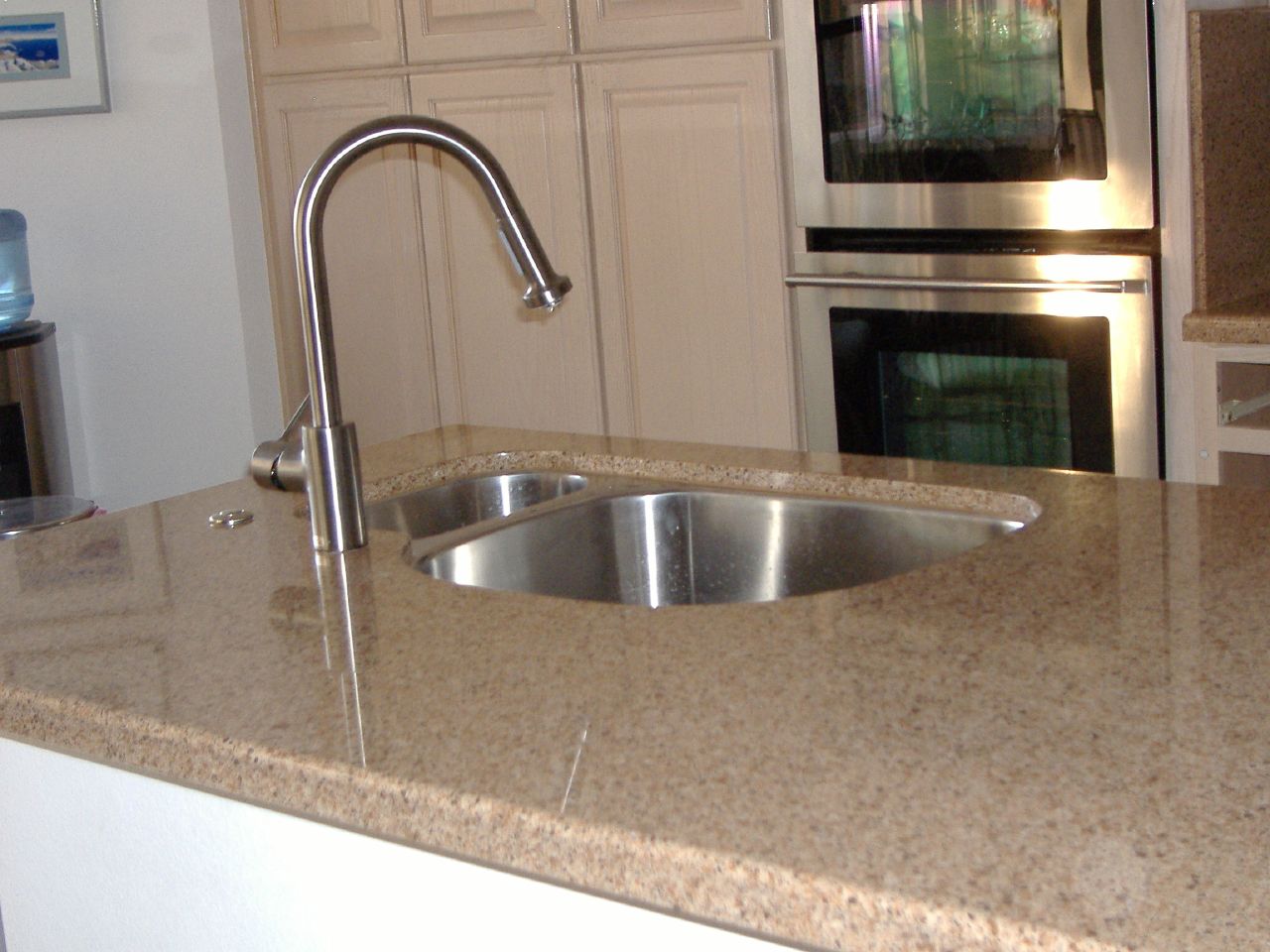a stainless steel sink in a large kitchen