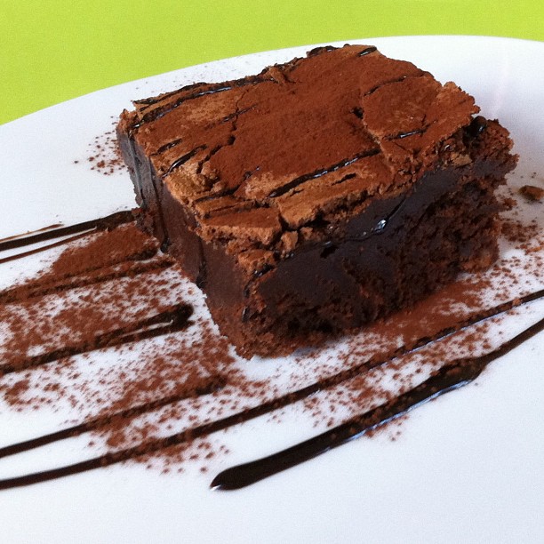 a piece of brownies is drizzled with chocolate