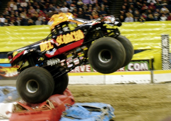 a person jumping over the top of a monster truck