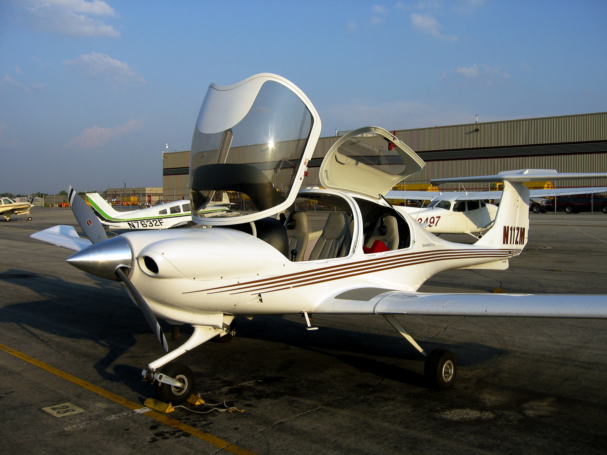 an airplane sitting on a runway next to a building