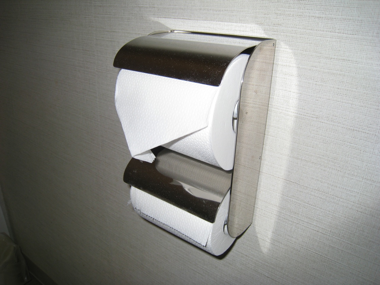 a roll of toilet paper is taped to a metal holder
