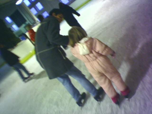 a girl in a pink jacket holding onto another person's back