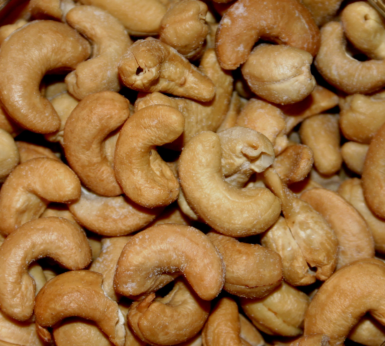 a bunch of uncooked whole cashews are in a bowl