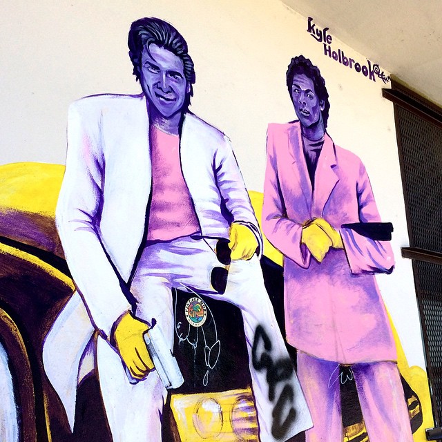 two people with painted uniforms standing on the side of a building