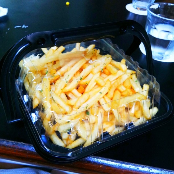 fries sitting inside a plastic container on a table