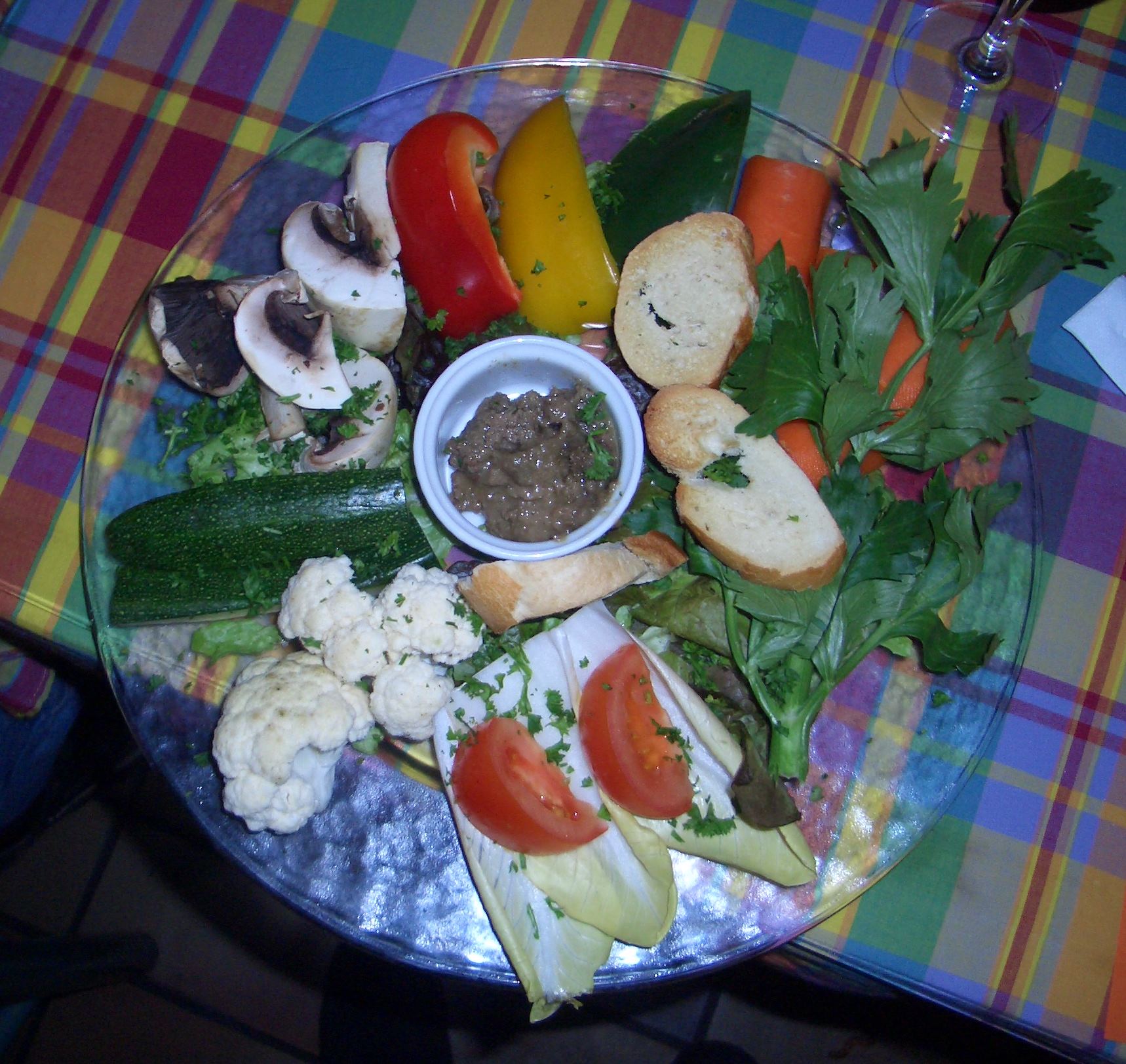 a plate full of food with various vegetables and food items