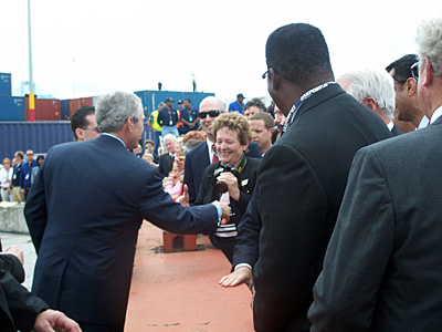 there is a man shaking hands with people at the end of the ceremony