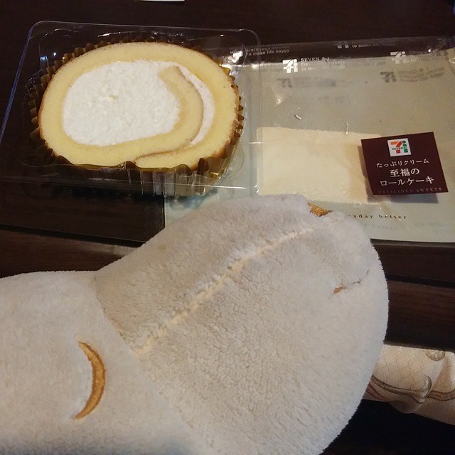a stuffed animal near a dessert in a case