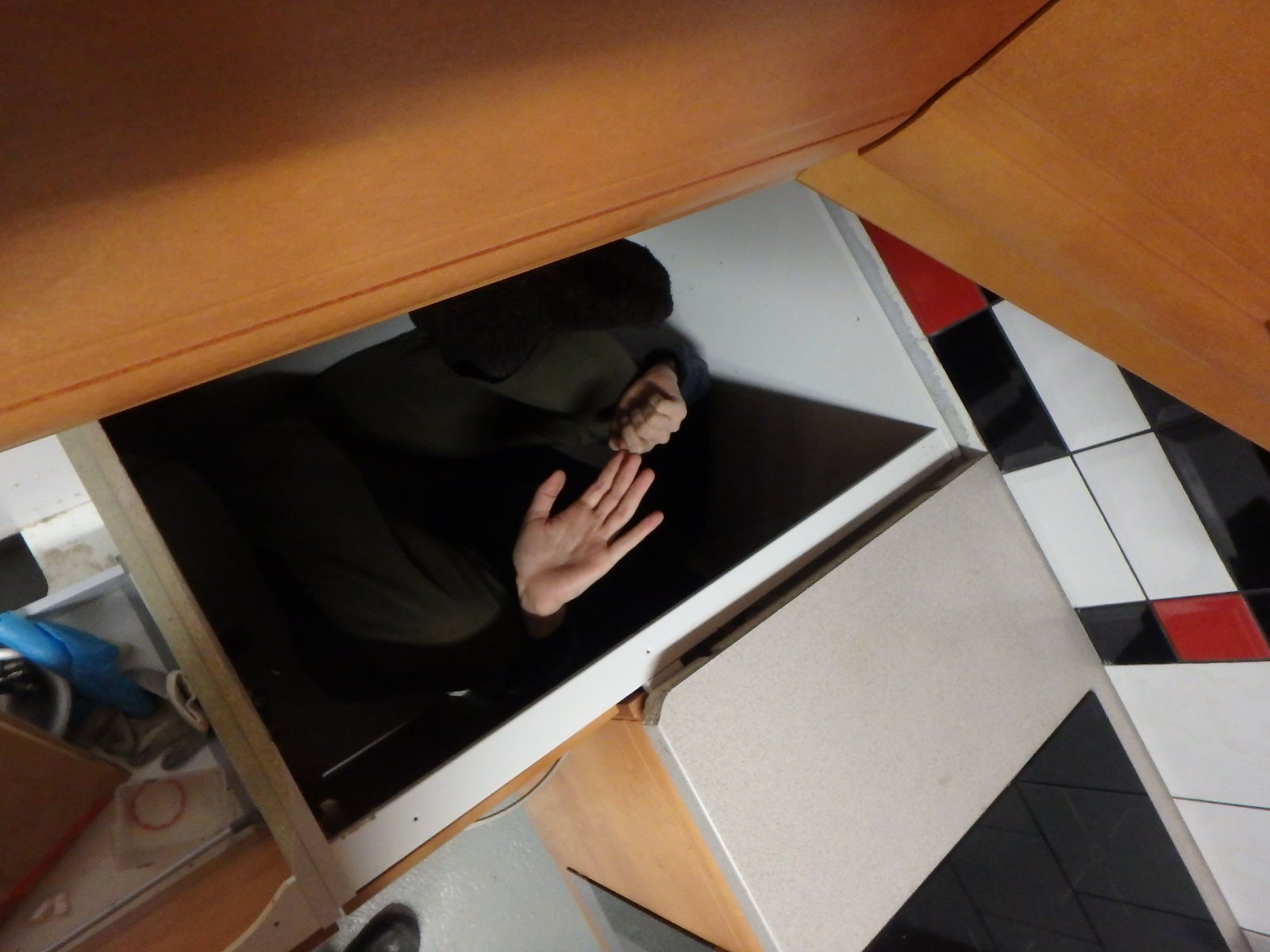 there is a man that is hiding in the cabinet