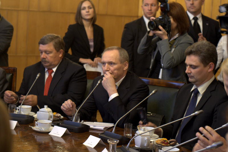 some men at a table with plates and cups