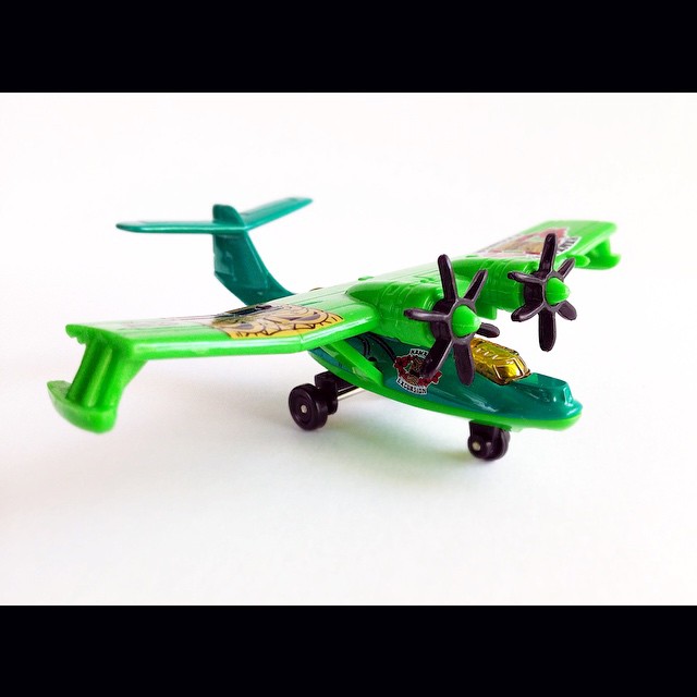 toy toy airplane with wheels, plastic body and black tires