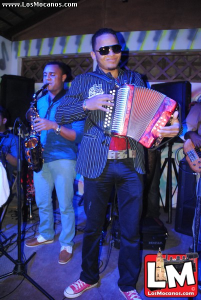 a man is holding an accordion and music equipment