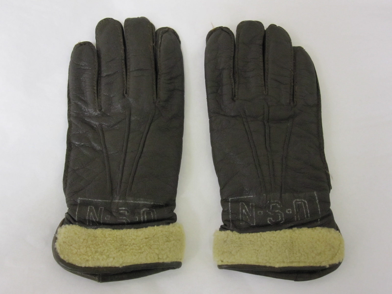 two grey leather gloves with yellow linings