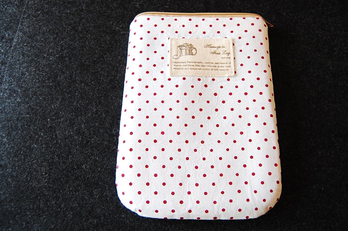 polka dots covered case laying on a carpet