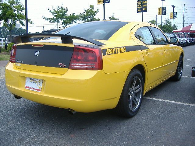 a yellow car with a caution sticker on the back