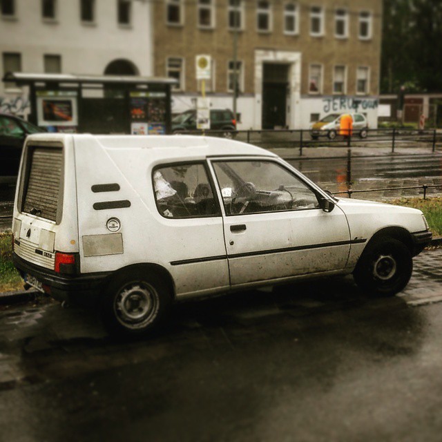 a white van parked on a wet parking lot