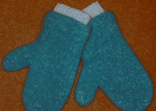 two mittens placed on a floor with one in the middle of it