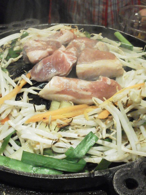food that includes chicken and some vegetables in a wok