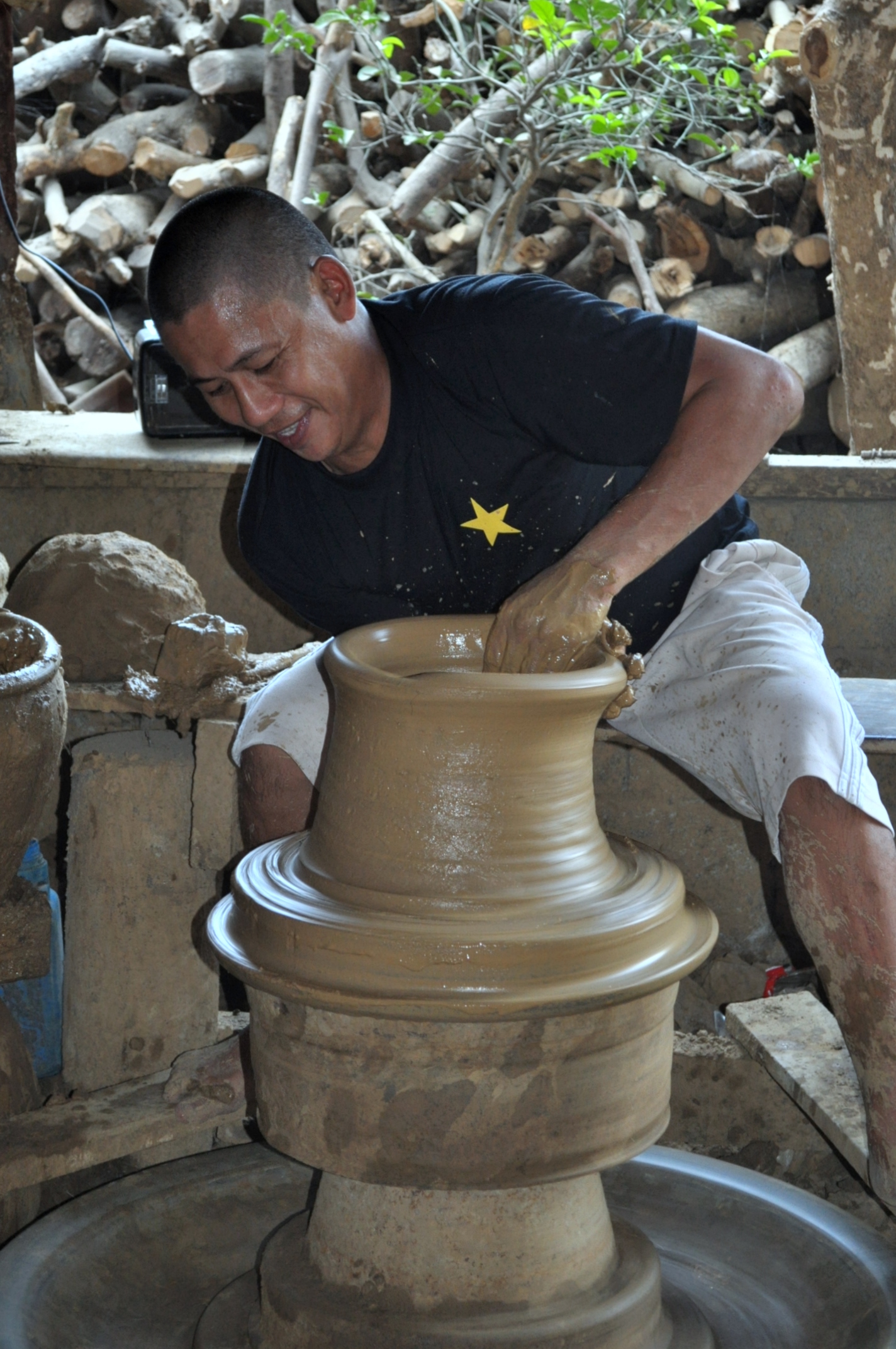 a man who is making some type of vase