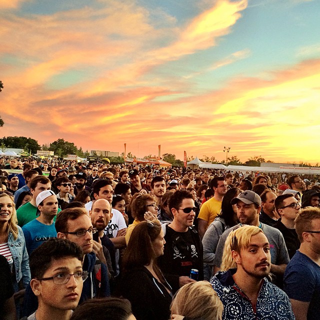 large crowd of people at outdoor festival setting