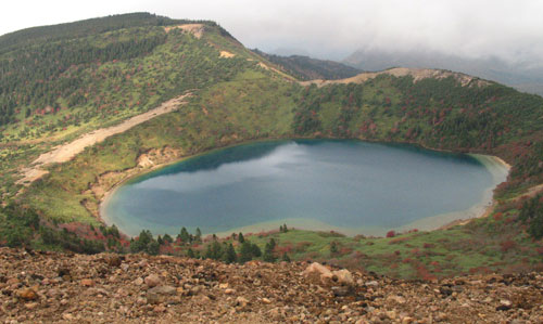 a view from a mountain of a lake and hills