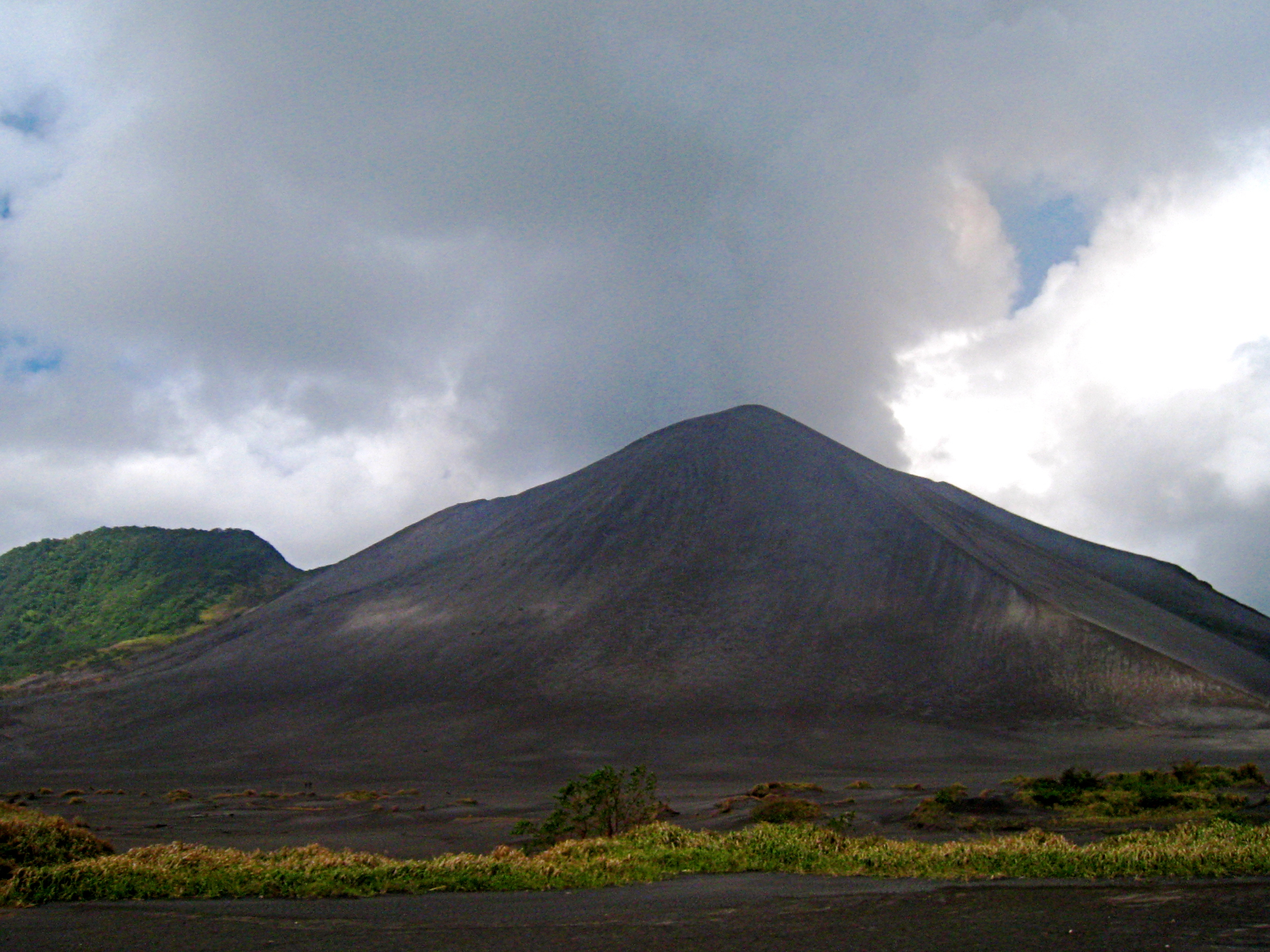 clouds fill the sky above a barren mountain