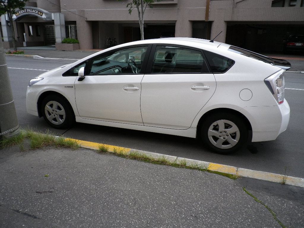 a white car parked in a parking space next to a curb