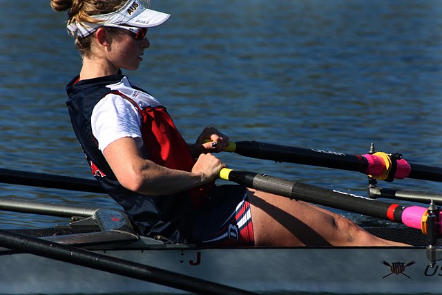 a rower sitting in the middle of her boat