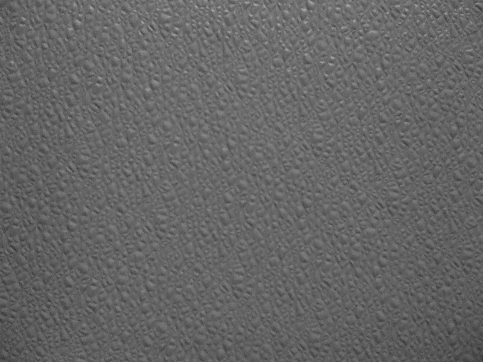 a gray surface that is covered in small specks