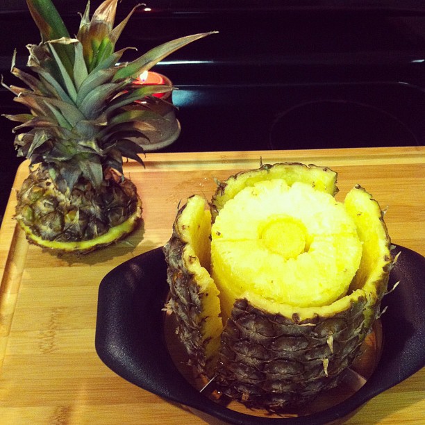 a pineapple that is cut and sitting on a table