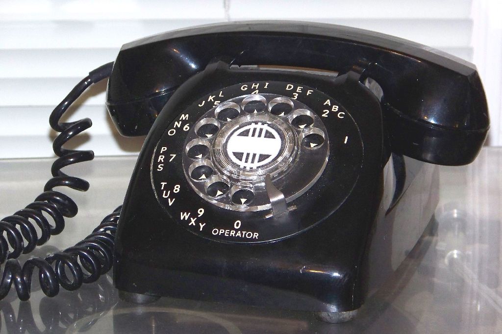 an old - fashioned phone is sitting on top of a table