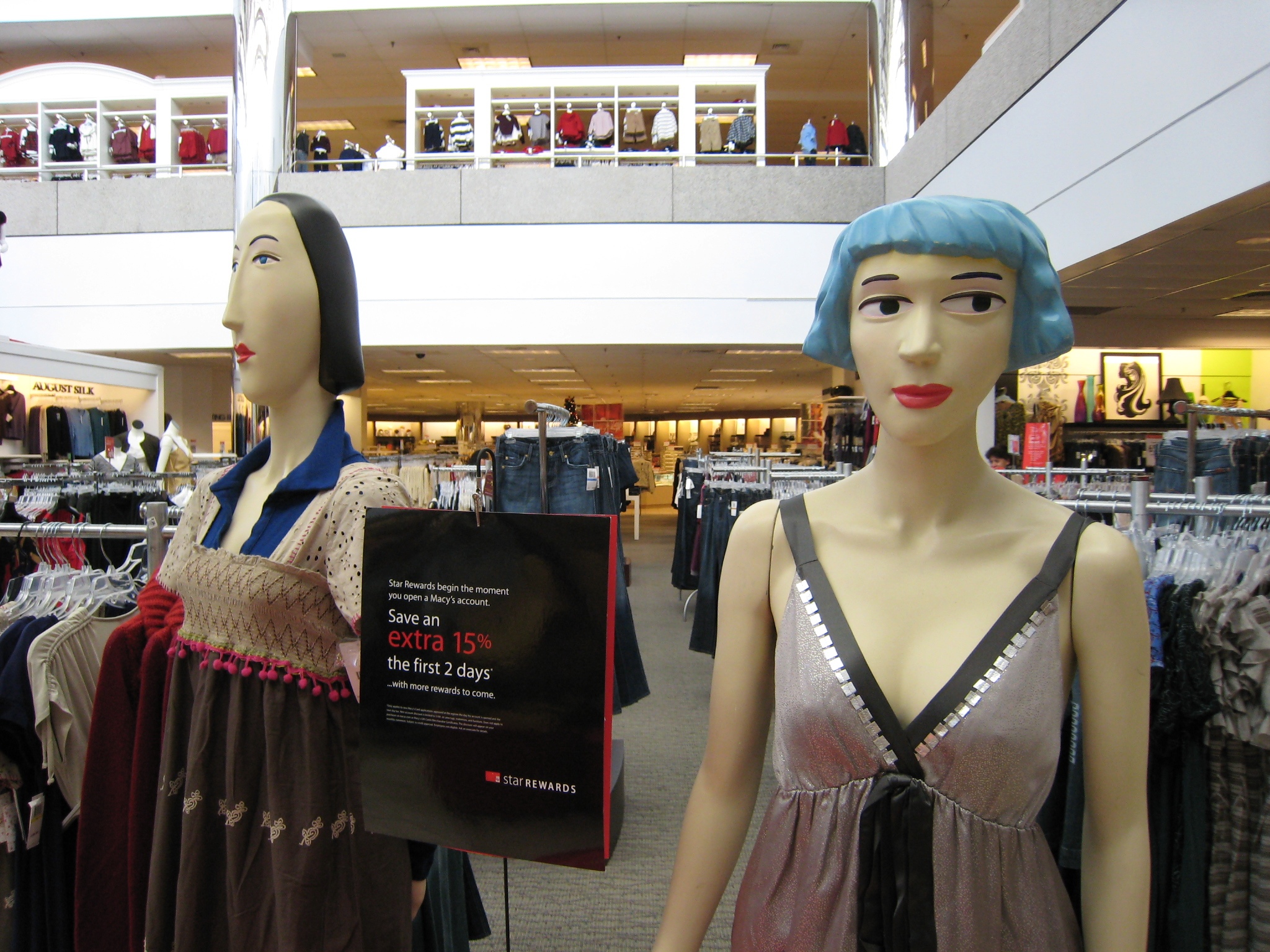 two mannequins, one in the process of making clothes