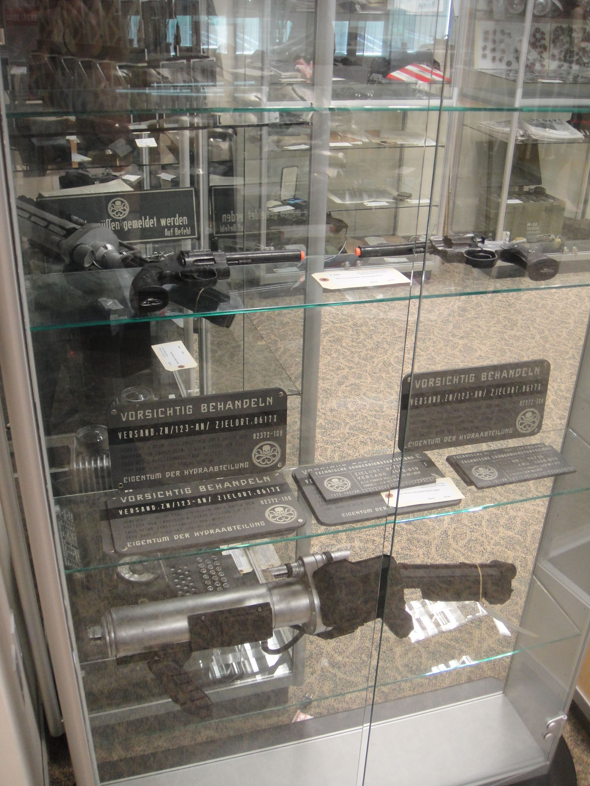 guns, guns and their cases on display