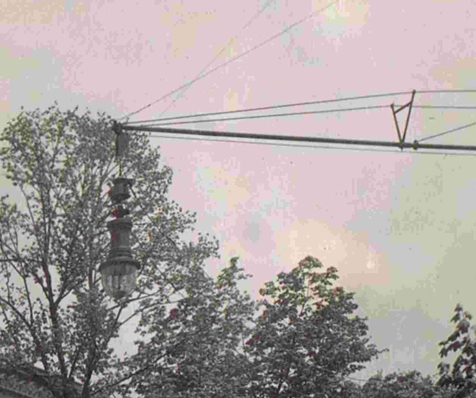 an intersection with telephone poles and trees