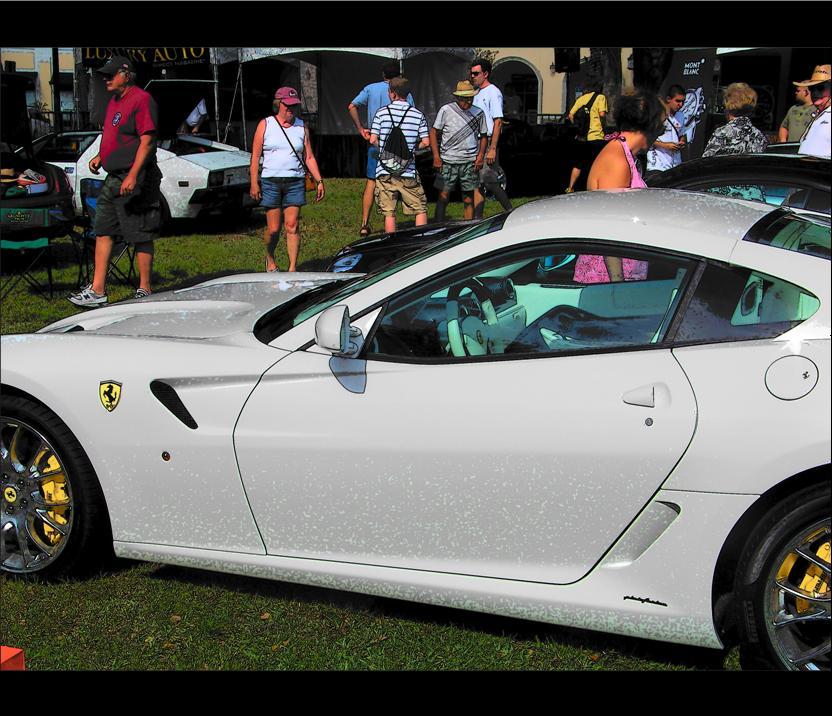 the white sports car is parked on the grass