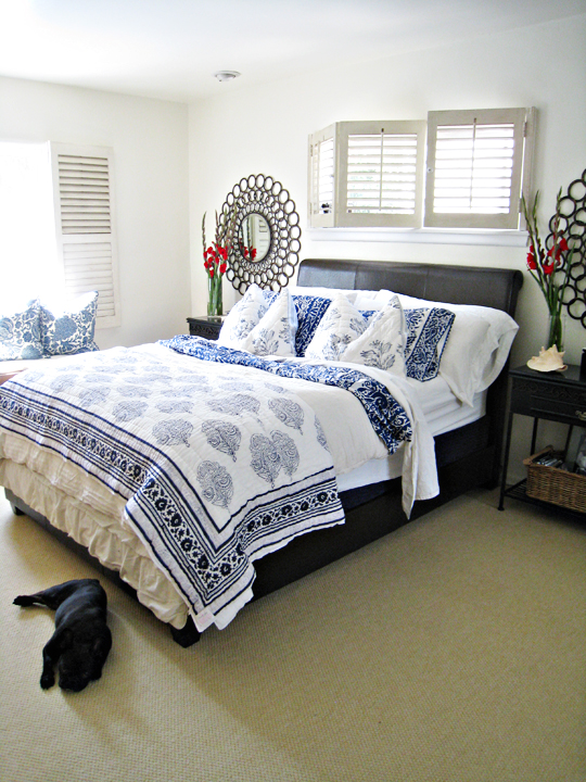 the bedroom has blue and white patterns on the bed