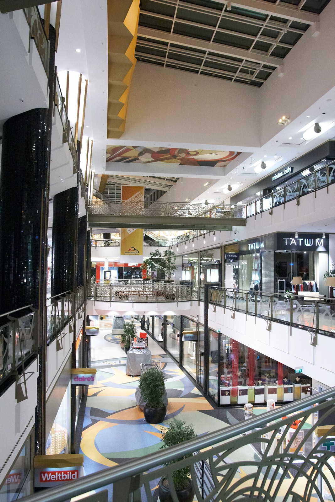 a large shopping mall with multiple shops and seating area