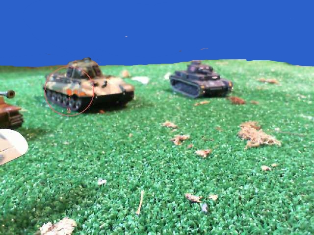various tanks and small tanks on green grass