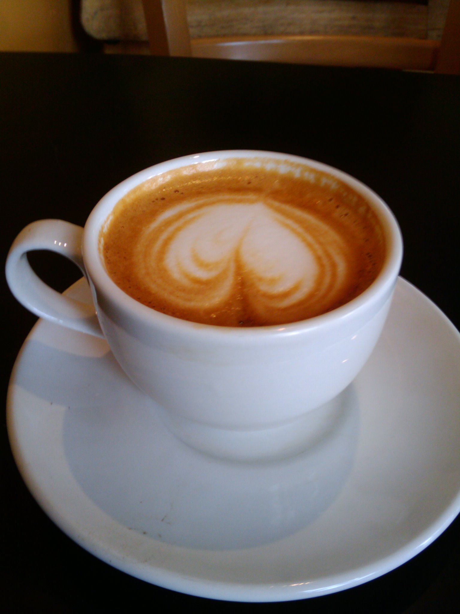 there is a cup of coffee on a saucer