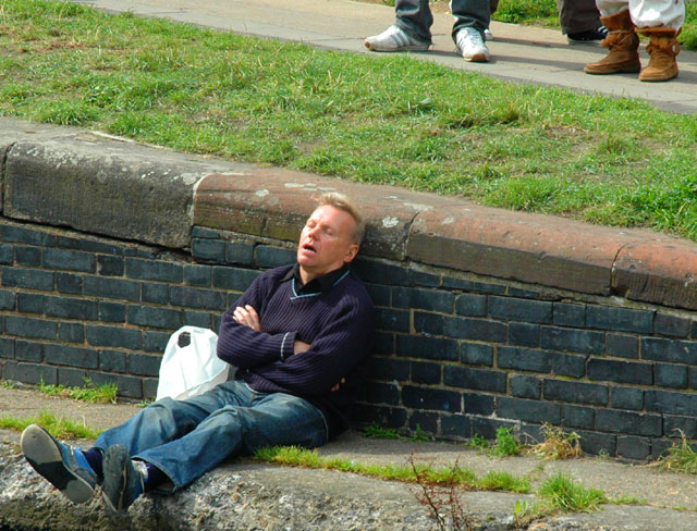 a man sits with his head on the ground
