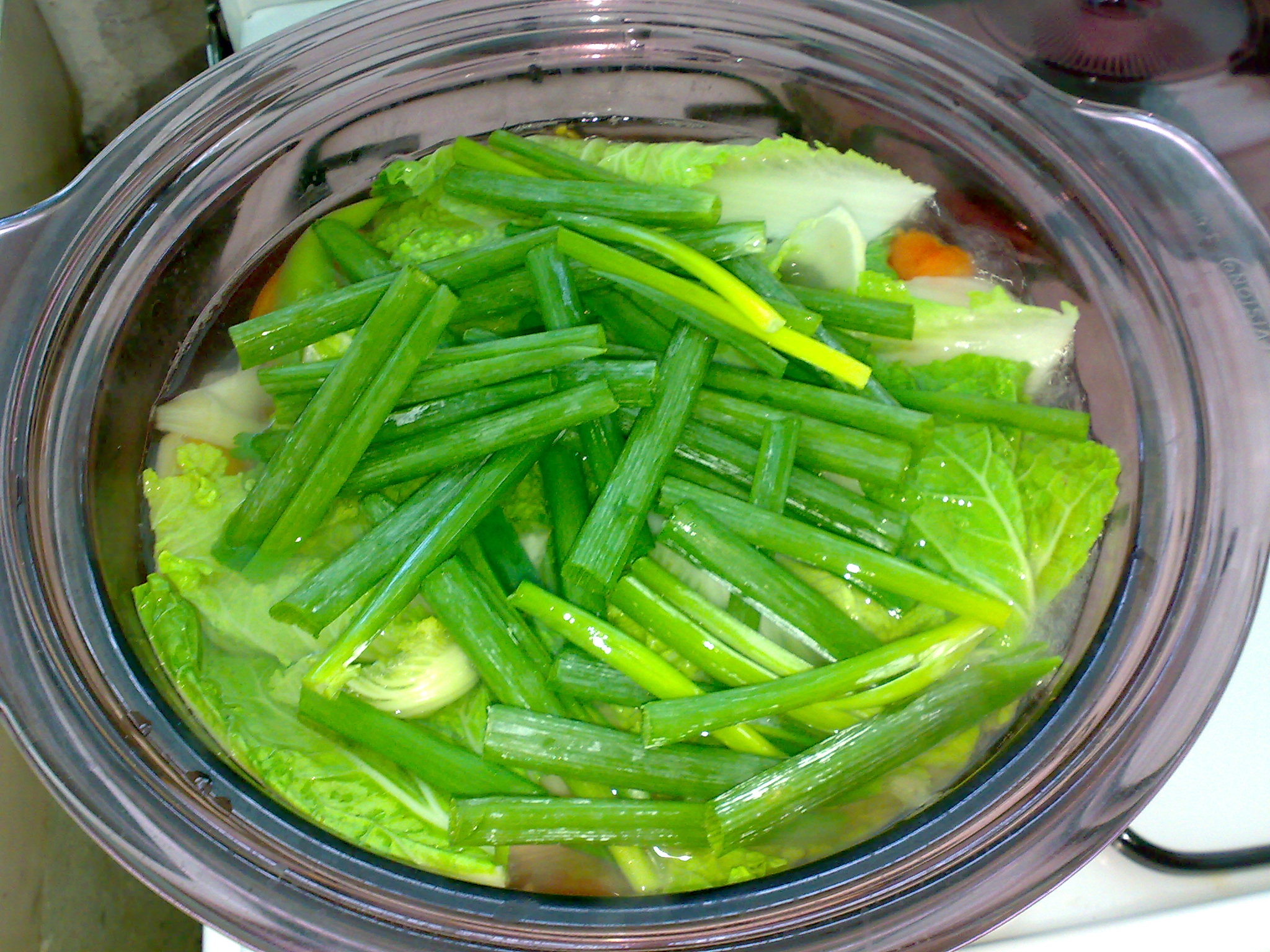 a bowl of some green vegetables sitting on a table