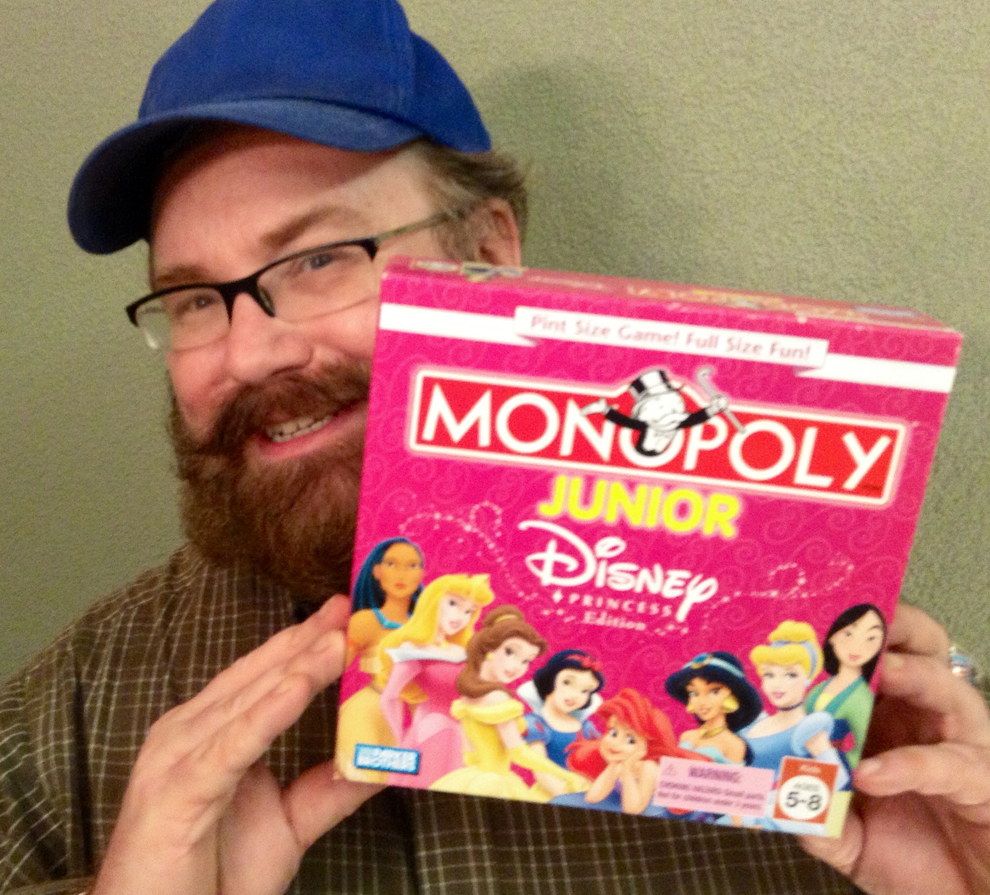 a man with a beard holding a box of monopoly for s