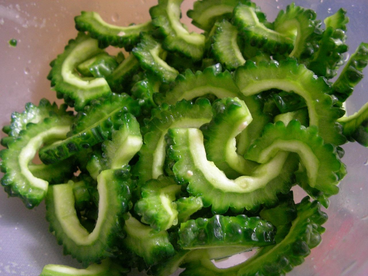 a pile of green vegetables that have been cut into smaller pieces
