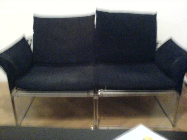 a black couch with some silver legs