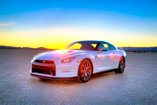 a white car parked on top of a dry field