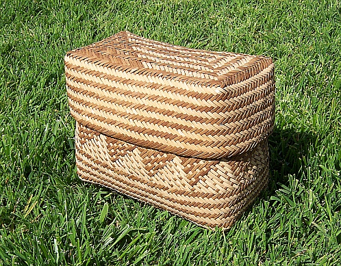 two wicker baskets sit on the grass